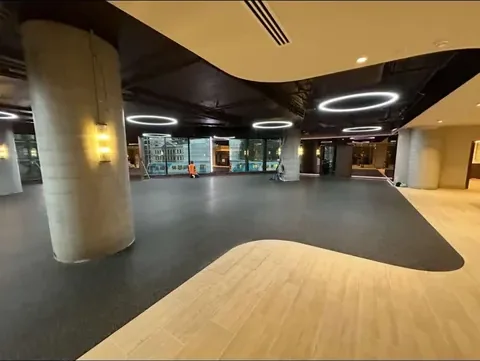 Studio floor with a curved timber inlay set into carpet