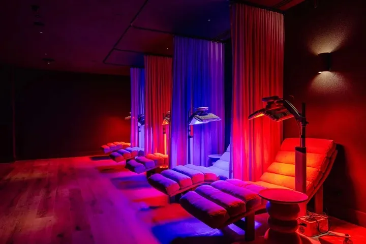 Recovery room finished in timber flooring under coloured lighting